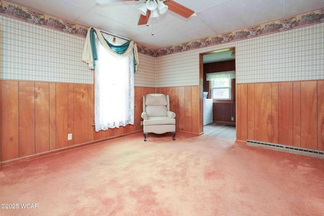 315 W Main St, Cairo, OH 45820 - living area with wallpapered walls, baseboard heating, wainscoting, ceiling fan, and washer / dryer