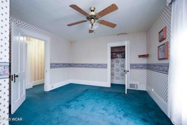 315 W Main St, Cairo, OH 45820 - unfurnished room with wallpapered walls, carpet flooring, a ceiling fan, and baseboards