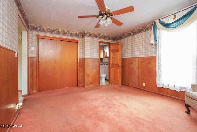 315 W Main St, Cairo, OH 45820 - unfurnished bedroom with wallpapered walls, a wainscoted wall, carpet floors, a closet, and ceiling fan
