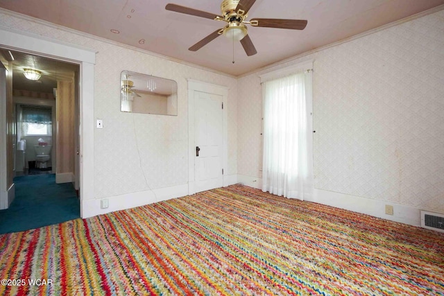 315 W Main St, Cairo, OH 45820 - carpeted spare room with ornamental molding, a ceiling fan, healthy amount of natural light, and wallpapered walls
