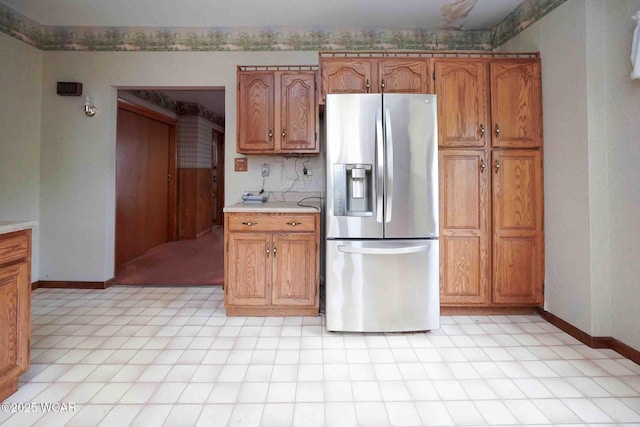 315 W Main St, Cairo, OH 45820 - kitchen featuring stainless steel fridge, brown cabinetry, light countertops, and baseboards