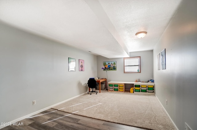 game room with visible vents, baseboards, a textured ceiling, and wood finished floors