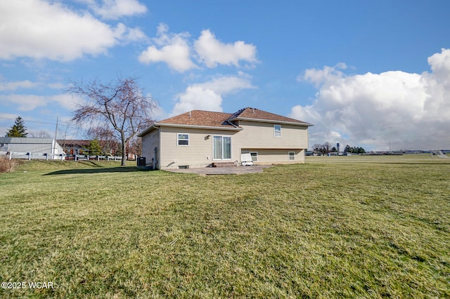 back of house featuring a patio and a yard