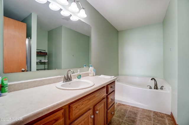 full bath featuring vanity and a garden tub