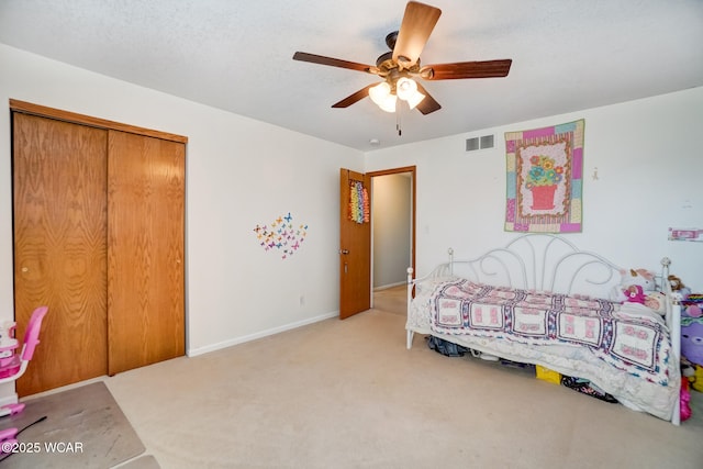 carpeted bedroom featuring visible vents, baseboards, a closet, and a ceiling fan