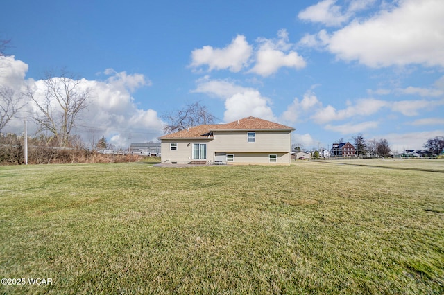 rear view of house with a lawn