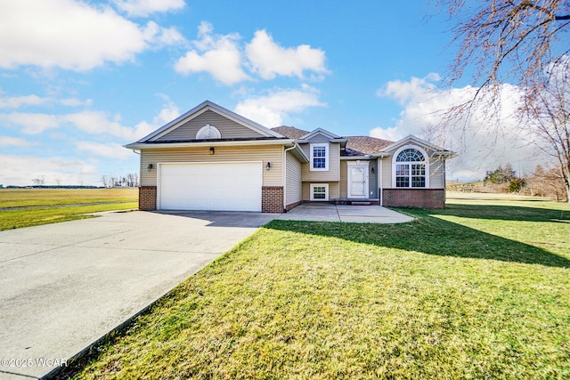 split level home featuring a garage, brick siding, concrete driveway, and a front lawn