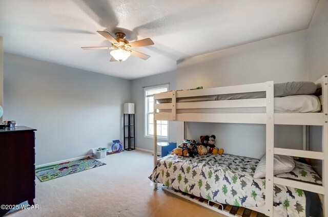 bedroom featuring ceiling fan, baseboards, and carpet