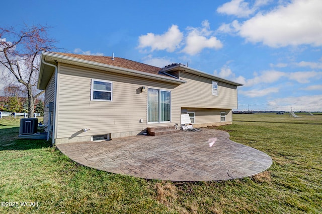 rear view of property featuring a patio area, central air condition unit, a lawn, and entry steps