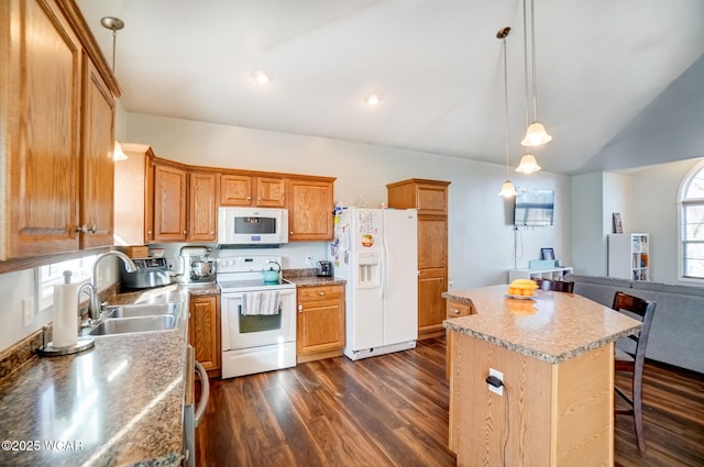 kitchen featuring a sink, a center island, white appliances, a breakfast bar area, and dark wood-style flooring