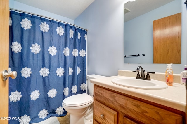 bathroom with visible vents, toilet, vanity, and a shower with curtain