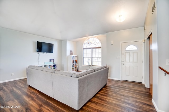 living area featuring visible vents, baseboards, and dark wood-type flooring