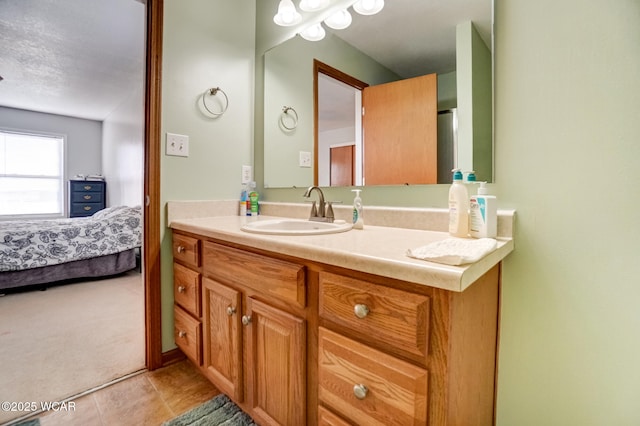 bathroom featuring ensuite bath, tile patterned flooring, and vanity
