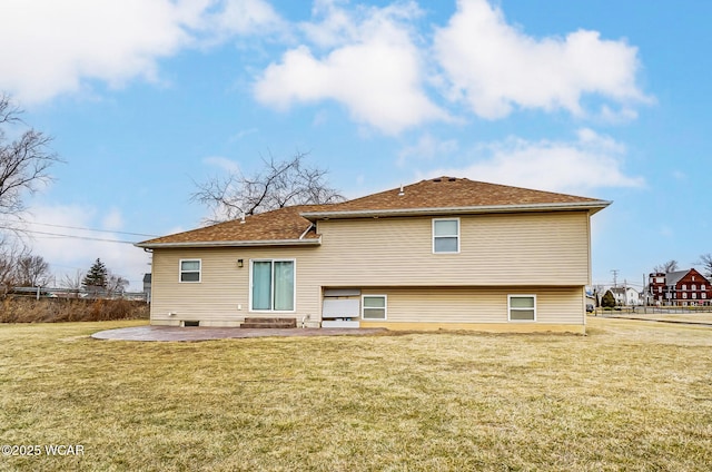 rear view of house featuring entry steps, a patio, a yard, and fence