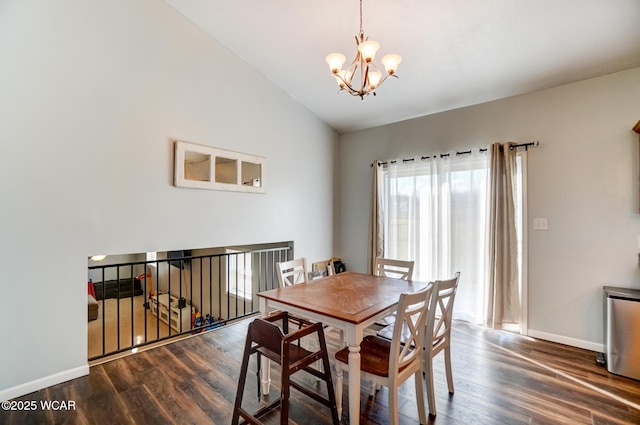 dining area with baseboards, wood finished floors, a chandelier, and vaulted ceiling