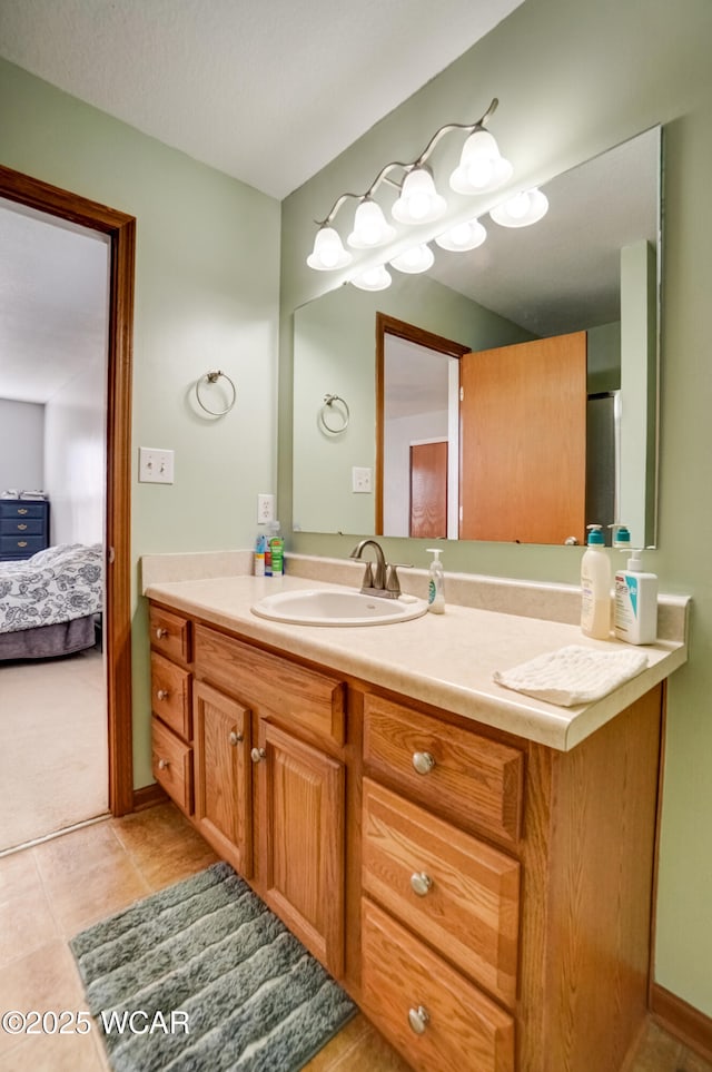 ensuite bathroom with tile patterned floors, ensuite bathroom, and vanity