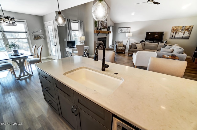 kitchen with sink, decorative light fixtures, and a wealth of natural light