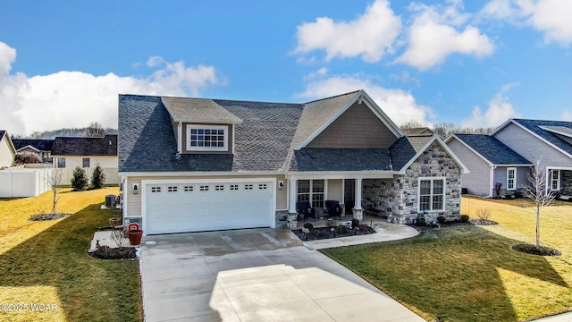 view of front facade featuring a garage, central AC unit, and a front lawn