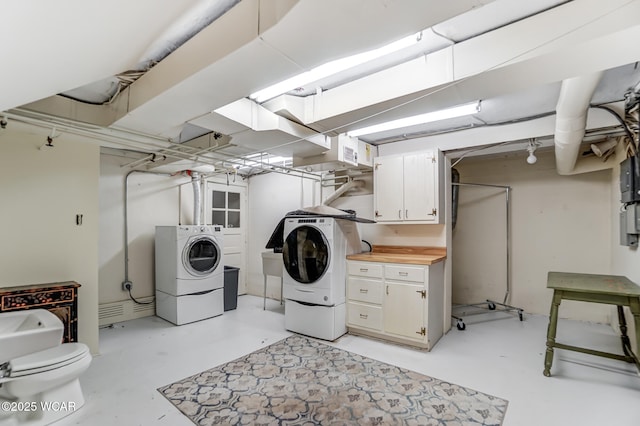 washroom featuring cabinets and independent washer and dryer