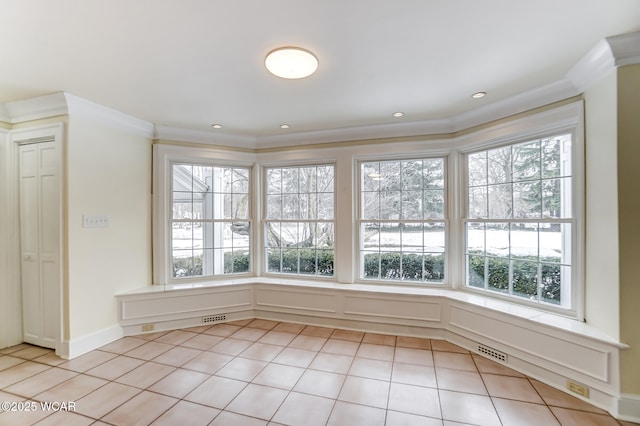 tiled spare room with crown molding and plenty of natural light