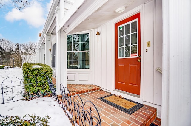 view of snow covered property entrance