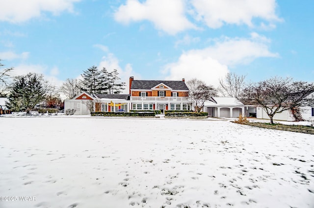 snow covered property featuring a garage