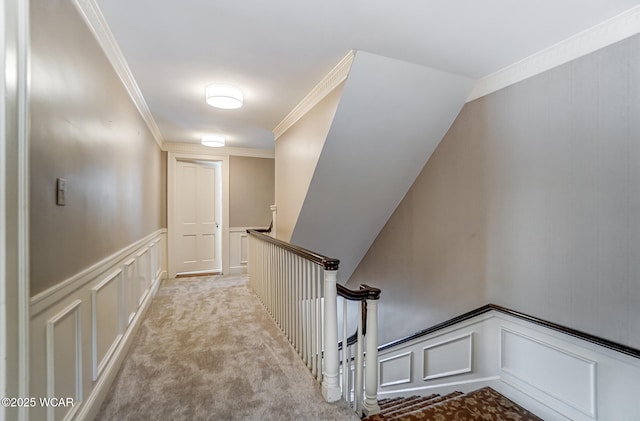 stairway featuring crown molding, vaulted ceiling, and carpet floors