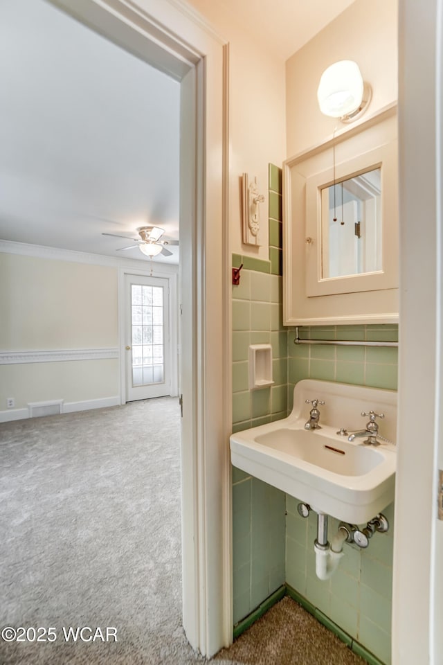 bathroom with tasteful backsplash, crown molding, and ceiling fan