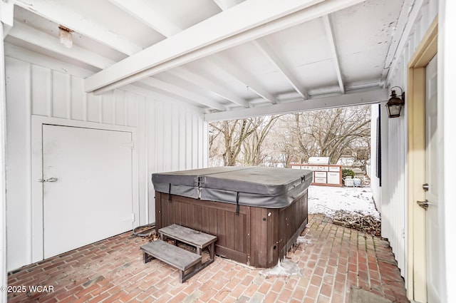 snow covered patio with a hot tub