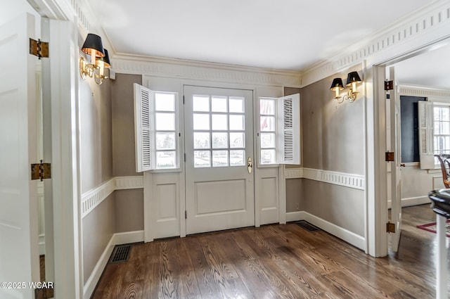 doorway to outside with dark wood-type flooring and ornamental molding