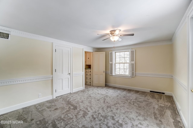 unfurnished bedroom featuring crown molding, light carpet, and ceiling fan