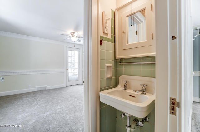 bathroom with crown molding, sink, backsplash, and ceiling fan