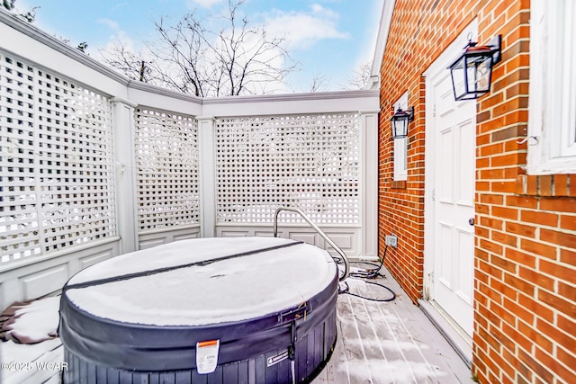 view of patio with a hot tub and a deck