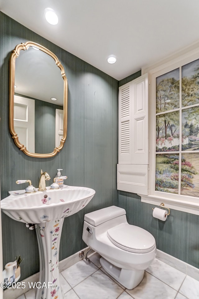 bathroom with toilet and tile patterned flooring