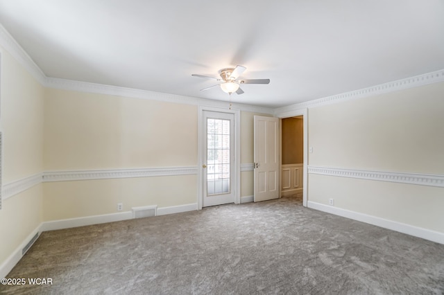 carpeted spare room featuring crown molding and ceiling fan