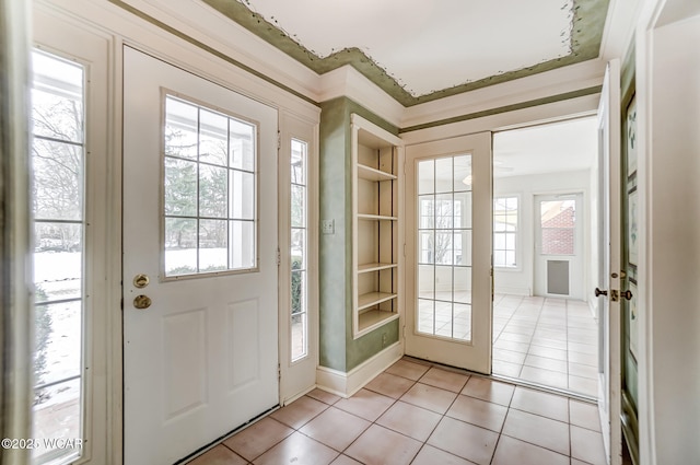 doorway with a healthy amount of sunlight and light tile patterned floors