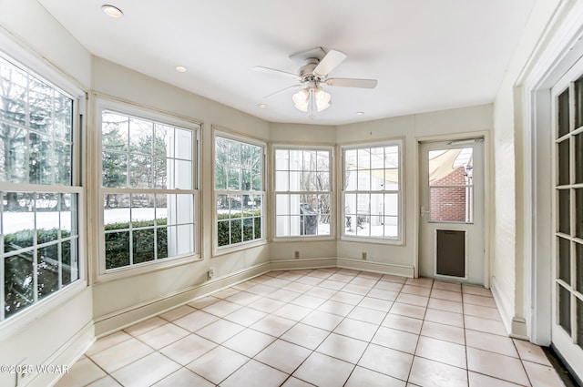 unfurnished sunroom featuring a wealth of natural light and ceiling fan