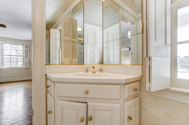 bathroom with ornamental molding and vanity