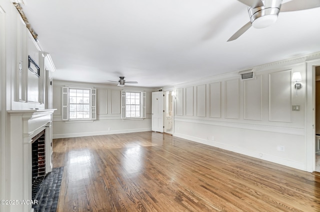 unfurnished living room featuring crown molding, hardwood / wood-style floors, and ceiling fan