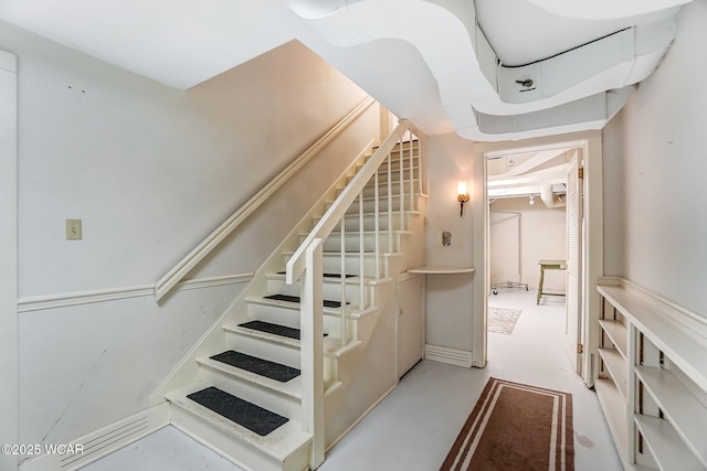 stairs featuring concrete floors