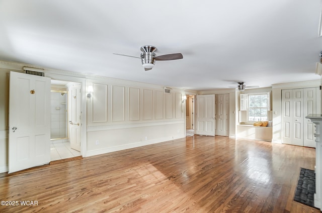 unfurnished living room with ceiling fan and light wood-type flooring