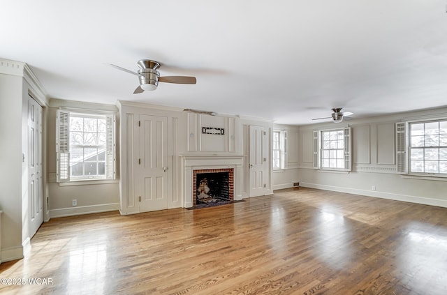 unfurnished living room with plenty of natural light, a fireplace, and light wood-type flooring