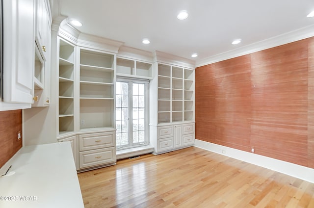 interior space with ornamental molding and light wood-type flooring