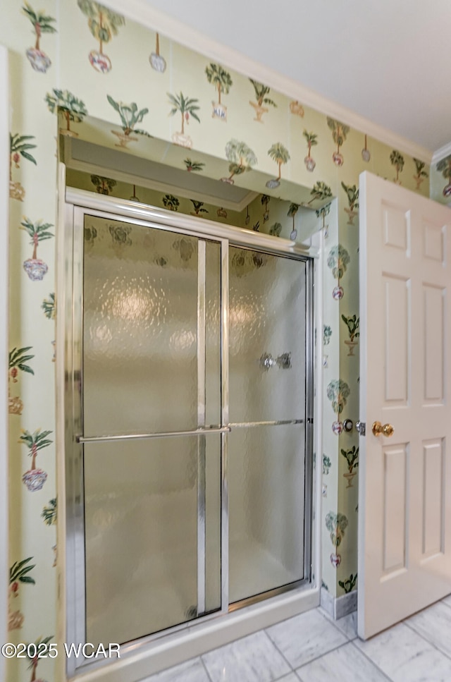 bathroom featuring crown molding, a shower with shower door, and tile patterned flooring