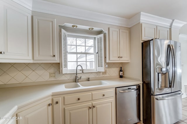 kitchen featuring crown molding, stainless steel appliances, sink, and backsplash