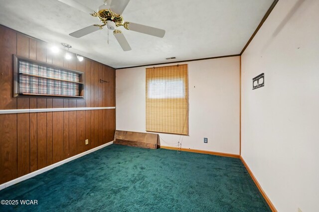 1398 Lutz Rd, Lima, OH 45801 - carpeted empty room featuring wood walls, baseboards, and ceiling fan