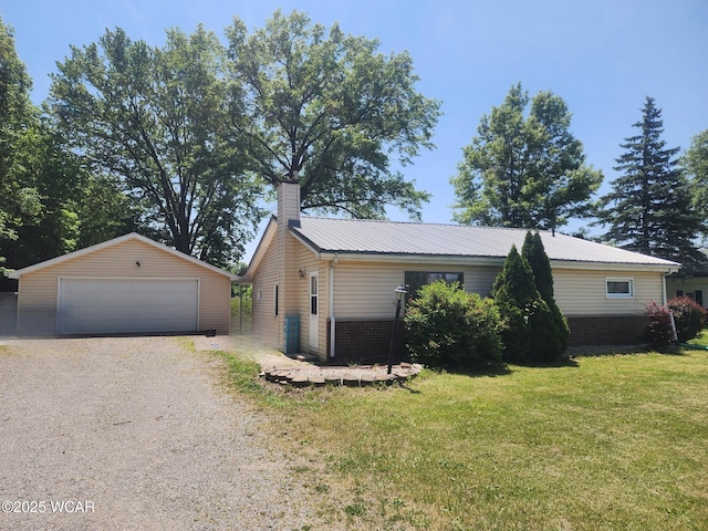 1398 Lutz Rd, Lima, OH 45801 - view of front of house with an outbuilding, a chimney, a garage, a front yard, and brick siding