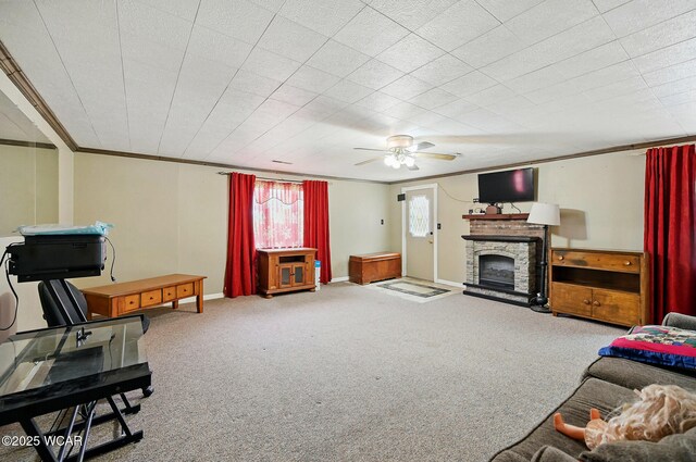 1398 Lutz Rd, Lima, OH 45801 - carpeted living room featuring crown molding, a stone fireplace, a ceiling fan, and baseboards