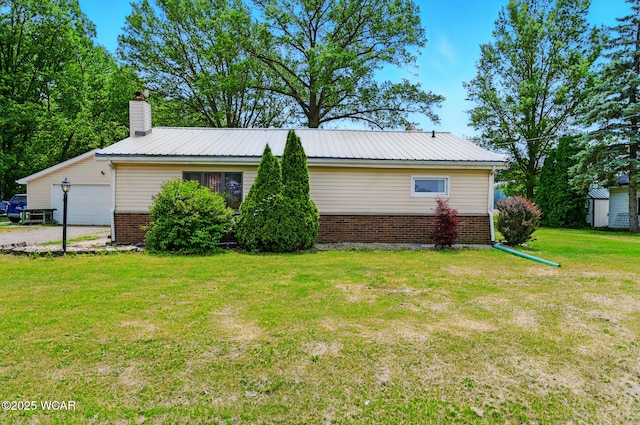 1398 Lutz Rd, Lima, OH 45801 - view of property exterior featuring brick siding, a lawn, metal roof, and a chimney