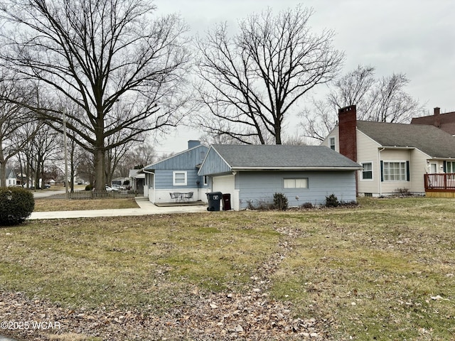 view of side of property with a yard